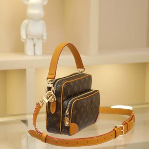 Alternative view of The Nil handbag is a compact fashion piece from the Monogram Archive collection, crafted from Monogram coated canvas with calf leather trim. It blends vintage details with contemporary elegance, featuring reinforced corners and Pharrell Williams' newly introduced pearl zipper. The removable handle and shoulder strap offer versatile carrying options. 17.5 x 11 x 25 cm(H x W x L)